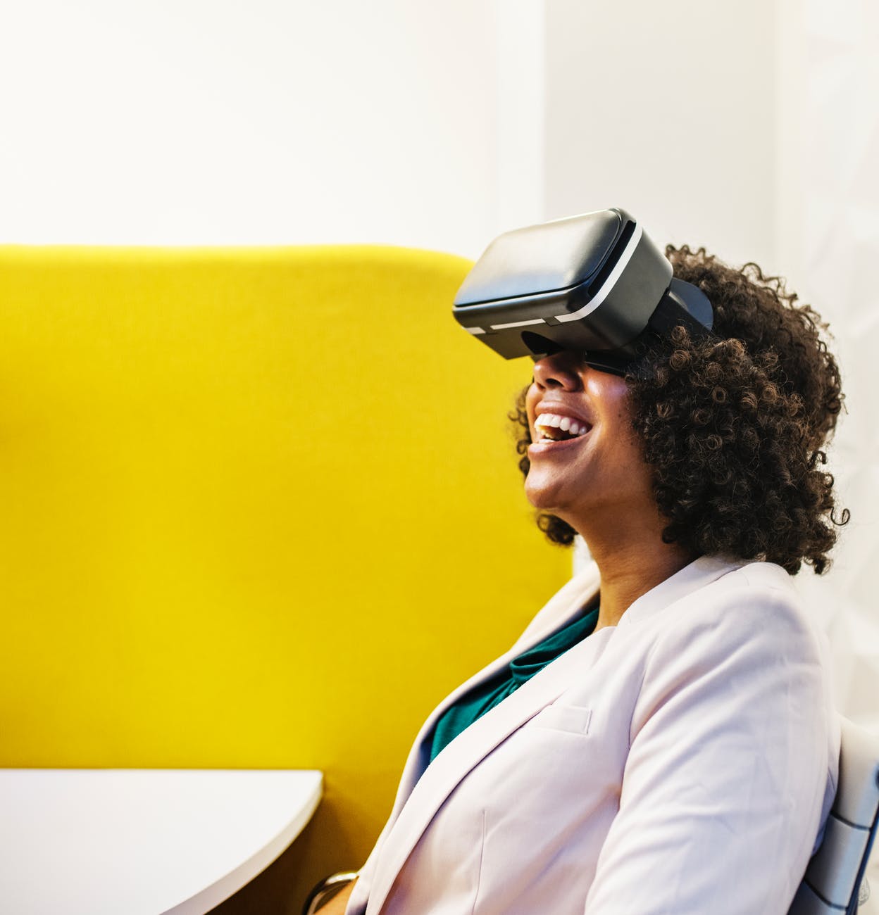 smiling woman using virtual reality headset